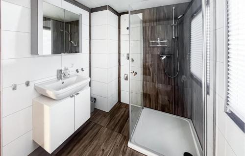 a white bathroom with a sink and a shower at Amazing Home In Oberelbert With 2 Bedrooms in Oberelbert