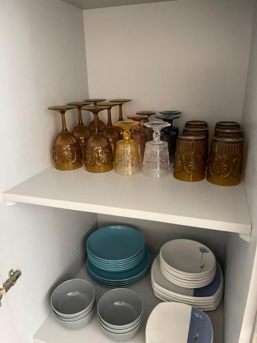 a shelf with plates and other dishes in a closet at Civico 21 in Noto