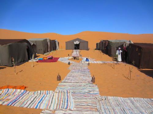 a group of tents in the desert at Merzouga Authentic Camps in Merzouga