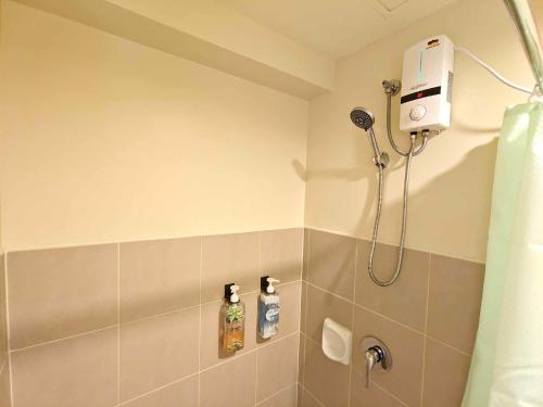 a bathroom with a shower with a shower head at Cebu Avida Riala T4 2320 IT Park in Cebu City