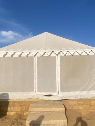 a white tent with a blue sky in the background at Jaisalmer Safari Base & Camp in Khuri