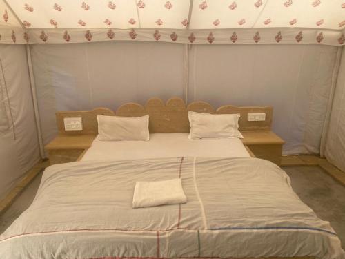 a large bed in a room with a large bedvisor at Jaisalmer Safari Base & Camp in Khuri