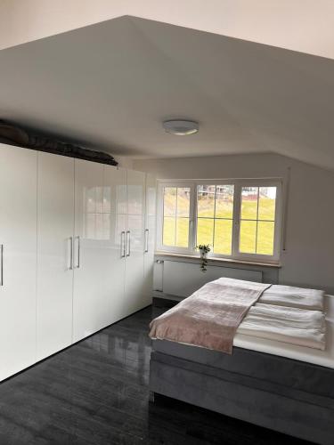 a bedroom with a large bed and a window at In der Leite in Oberstdorf