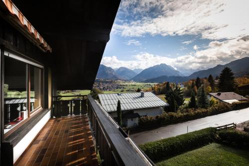 a balcony of a house with a view of the mountains at In der Leite in Oberstdorf