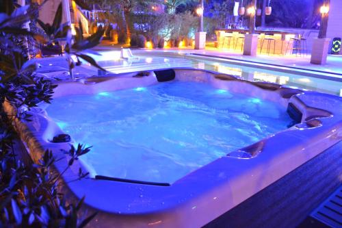 a jacuzzi tub in a backyard at night at Farm Lebanon in Abu Dhabi