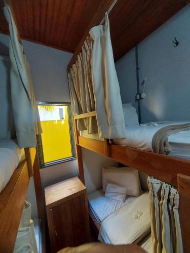 a room with two bunk beds and a mirror at HOSTEL BADULACK in Capitólio