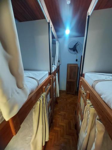 two bunk beds in a room with a light at HOSTEL BADULACK in Capitólio