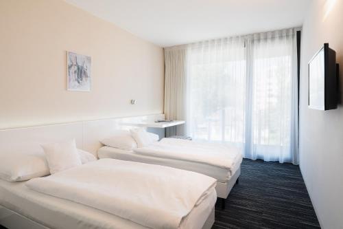 Postel nebo postele na pokoji v ubytování Fabrika Hotel
