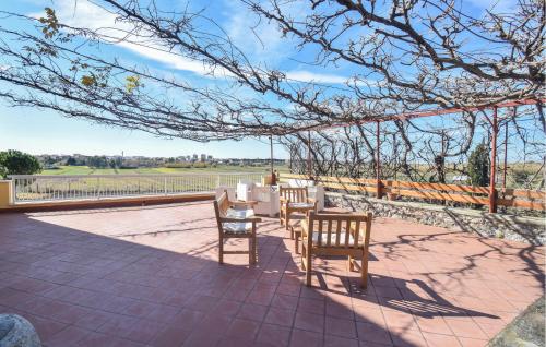 a group of chairs and tables on a patio at 3 Bedroom Stunning Home In Mondragone in Mondragone