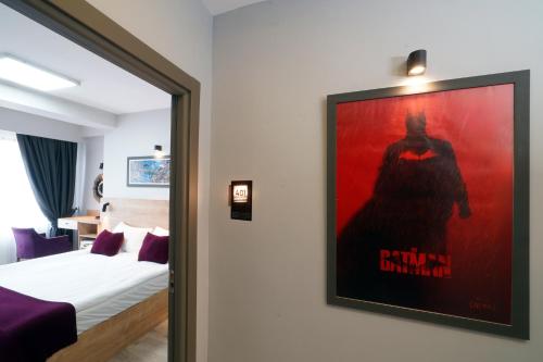 a bedroom with a poster of a superhero on the wall at Meet İstanbul Hotel Kadikoy in Istanbul
