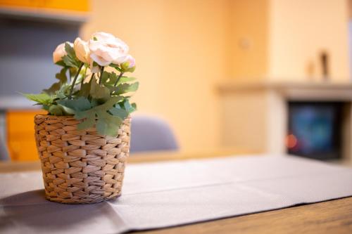 a vase filled with pink roses sitting on a table at Вили Тихия Кът in Ribarica
