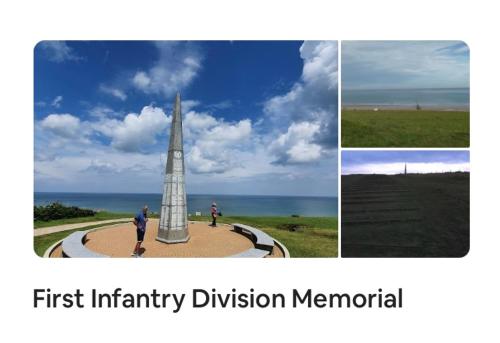 a man is standing next to a monument at Au Coeur d'Omaha Beach - Colleville-sur-Mer - Gîte 1 in Colleville-sur-Mer