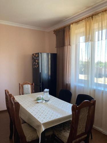 a kitchen with a table and a refrigerator in a room at Тигран in Sevan