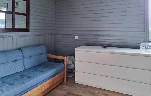 a room with a bench and a dresser and a window at Awesome Apartment In ysleb With House Sea View in Marnardal