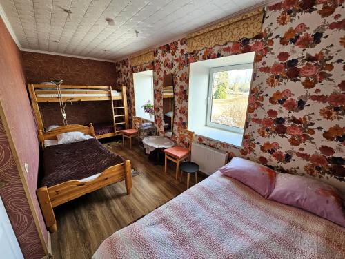 a bedroom with two bunk beds and a window at Šubrakkrasti in Vestiena