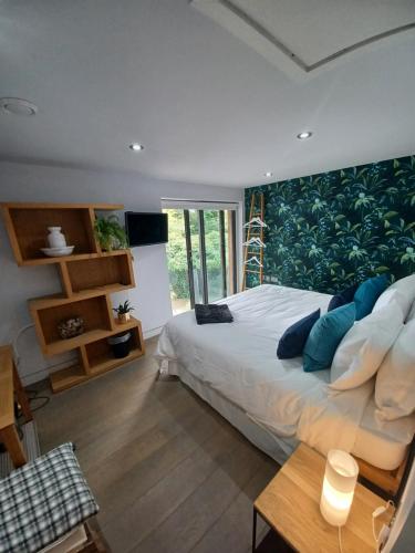 a bedroom with a large bed with blue pillows at Pound Orchard Bed and Breakfast in Petersfield