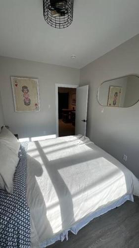 a bedroom with a large white bed in a room at Modern One Bedroom Suite in Halifax