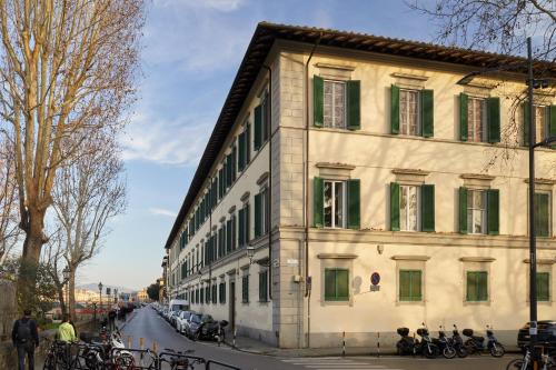 a large white building with green shutters on a street at Santarosa Rooms in Florence