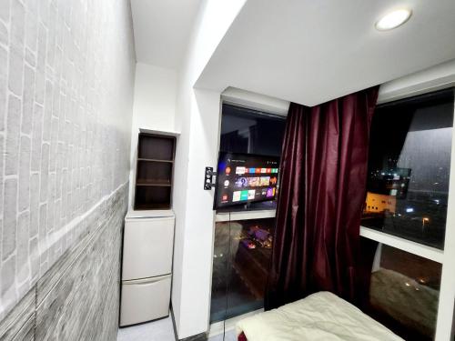 a room with a bed and a window with a curtain at Panoramic Partation with Amazing View close to Mall Of Emirates in Dubai