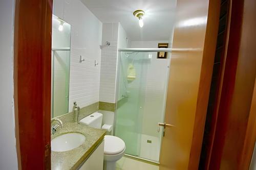 a bathroom with a toilet and a sink and a shower at Atlantis Cabo Branco by Allmare Apartamentos in João Pessoa