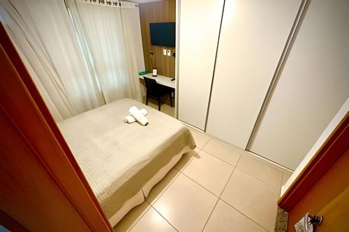 a small room with a bed and a mirror at Luxor Paulo Miranda 409 by Allmare Apartamentos in João Pessoa