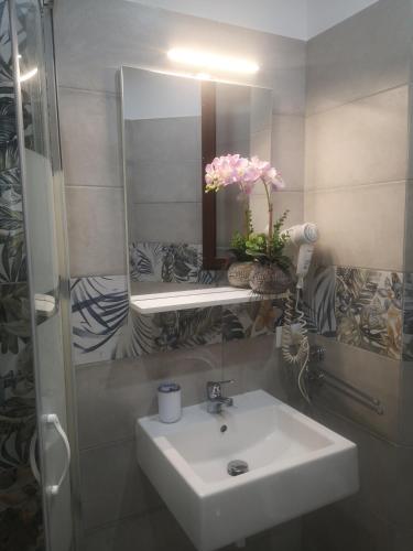 a bathroom with a white sink and a mirror at Casa vacanza da Samuele in San Vito lo Capo