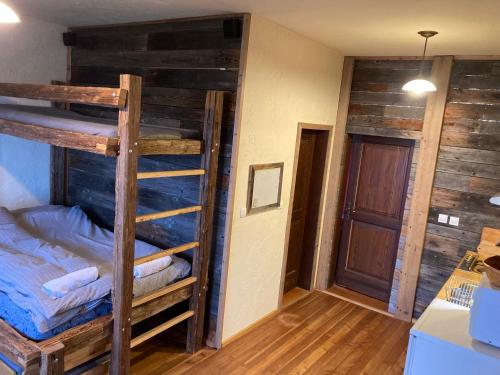 a room with two bunk beds and a hallway at Razborca in Mislinja
