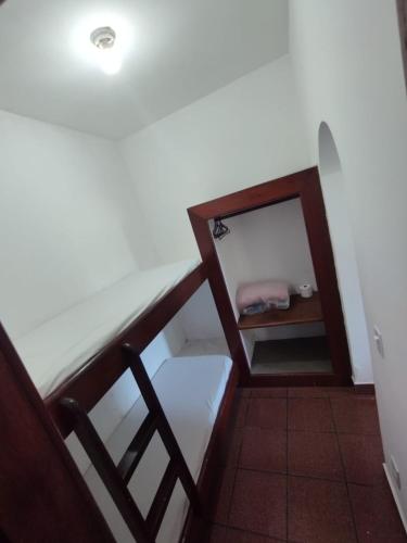 a room with a staircase with a mirror on it at Guarapousada in Guarapari