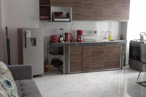 a kitchen with a counter and a refrigerator at New Apartment in Historic City Center in Cusco