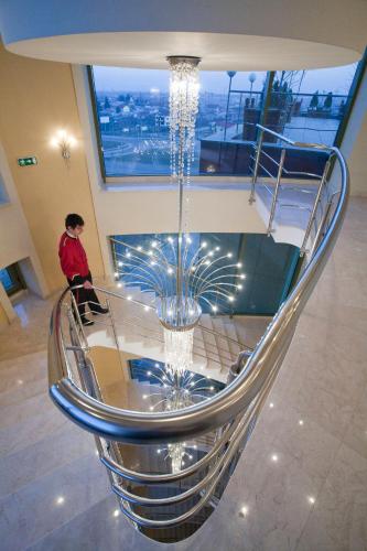 a chandelier hanging from the ceiling of a building at Mari Vila Hotel in Bucharest