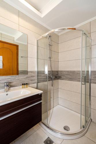 a bathroom with a shower and a sink at Kamari Beach in Lardos