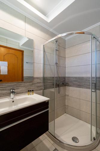 a bathroom with a shower and a sink at Kamari Beach in Lardos