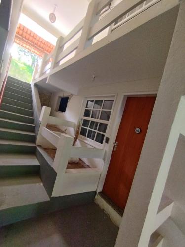 a staircase leading up to a house with a door at Guarapousada in Guarapari