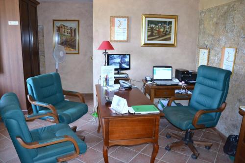 an office with two chairs and a desk with a computer at Residenza La Vigna in Parghelia