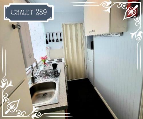 a small kitchen with a sink and a stove at THE CHALETS 217 & 289 in Withernsea