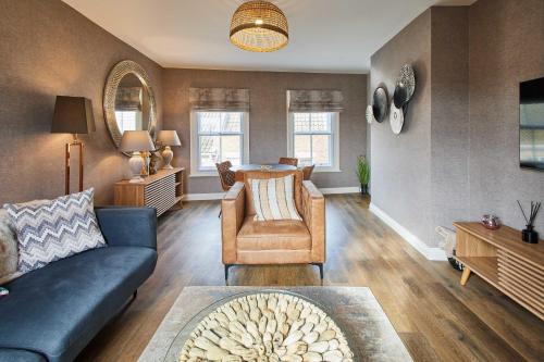 a living room with a couch and a chair at Host & Stay - Baxtergate Apartments in Whitby