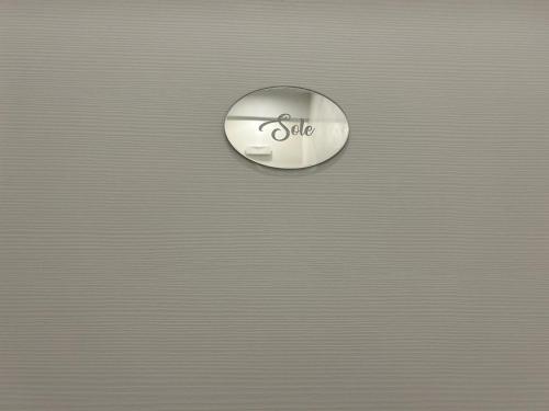 a button with the word allele on a metal wall at B&B Il Sogno in Lamezia Terme