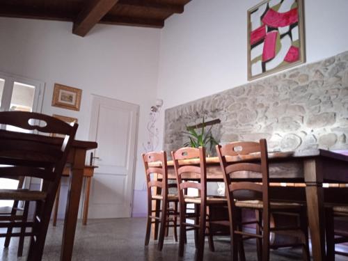 a dining room with a wooden table and chairs at Locanda di Campagna in Mulazzo