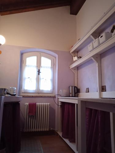 a kitchen with a window and a radiator at Locanda di Campagna in Mulazzo