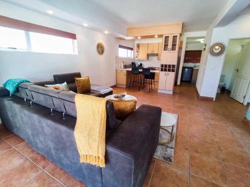 a living room with a couch and a kitchen at Waterfront G2 Self Catering Unit in Swakopmund