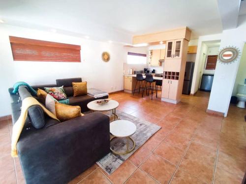 a living room with a couch and a table at Waterfront G2 Self Catering Unit in Swakopmund