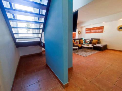a living room with a blue wall and a couch at Waterfront G2 Self Catering Unit in Swakopmund