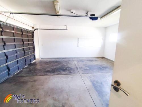 an empty garage with a concrete floor and a door at Waterfront G2 Self Catering Unit in Swakopmund