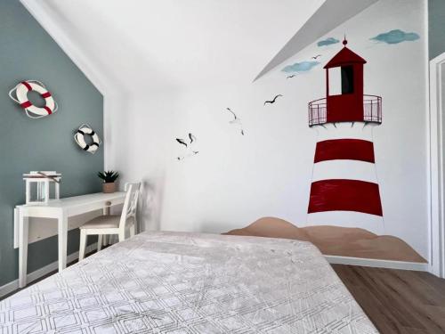 a bedroom with a red and white lighthouse on the wall at Apartament Łeba Piaskowa Ostoja in Żarnowska