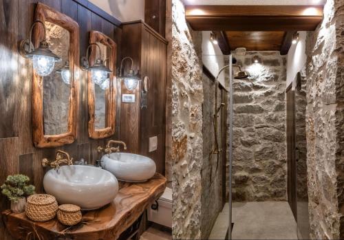 2 wastafels in een badkamer met een stenen muur bij Talići Hill - Rustic Villas in Sutomore