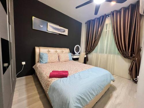 a bedroom with a bed with red pillows on it at Eden Height Cozy & Spacious Condominiums in City of Kuching in Kuching
