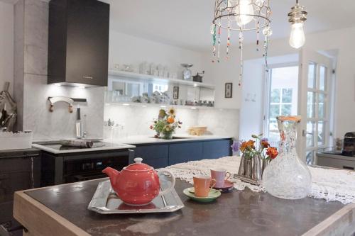 a kitchen with a red tea pot on a counter at Exklusives Landhaus in den Bergen in Arzl im Pitztal