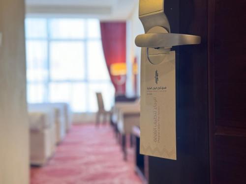 a door with a door tag on it with a room at فندق أبراج الريان المكية Al Rayyan Makiya Towers Hotel 1 in Makkah