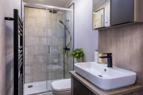 a bathroom with a sink and a shower at Seaton Estate in Arbroath