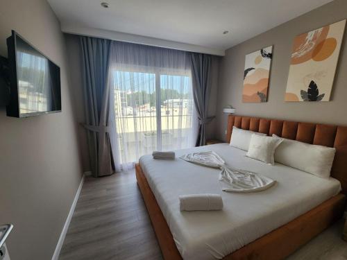 a bedroom with a bed with a plate on it at Hotel Maren Durres in Durrës